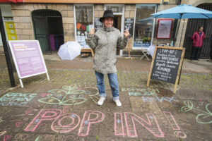 Artist Rosie Balyuzi puts her mark on the street in the town square outside 86 High Street. Pic: Marc Hindley